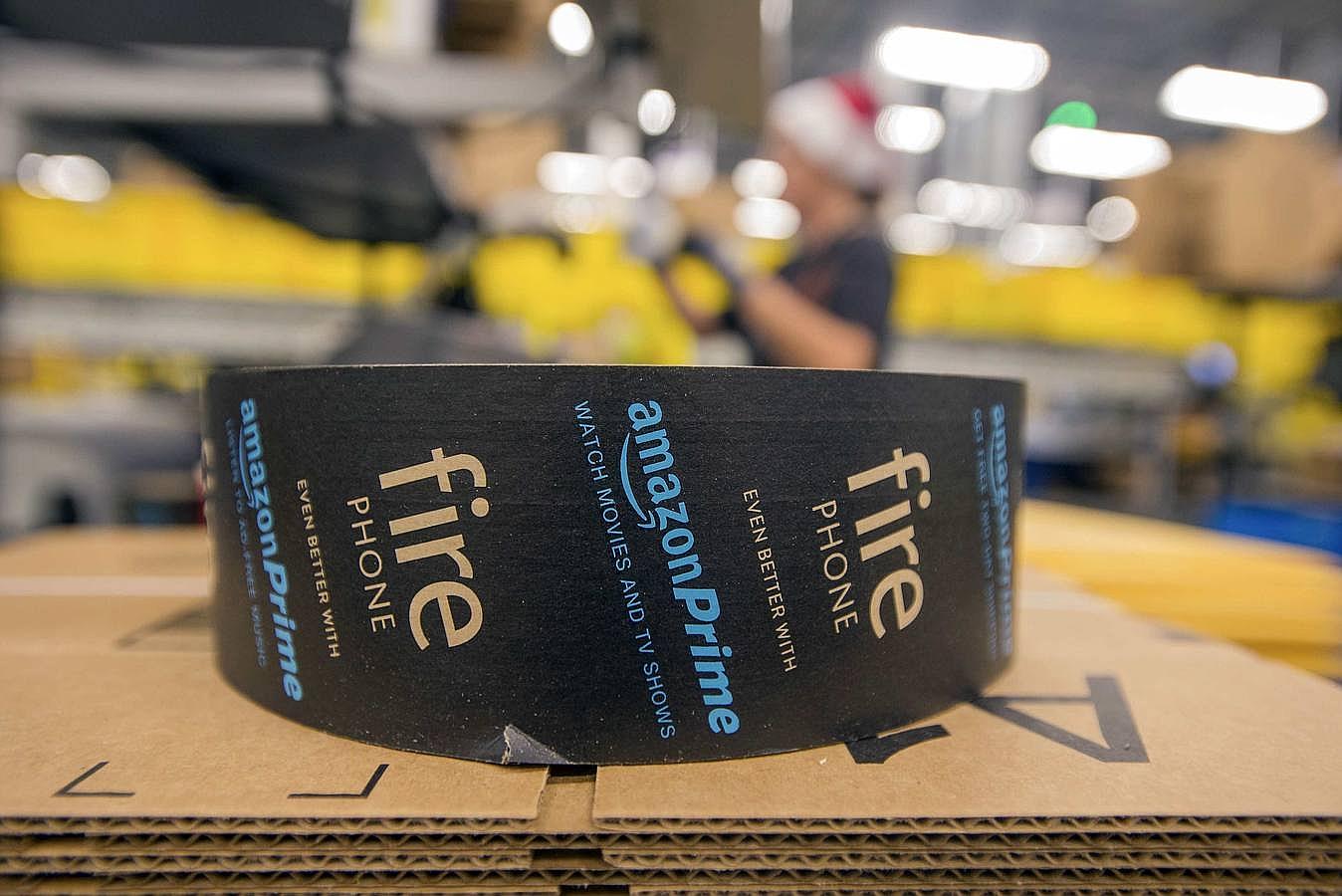 Amazon aprovecha para hacer publicidad de su móvil Fire Phone en las cintas americanas que se usan para el embalaje 