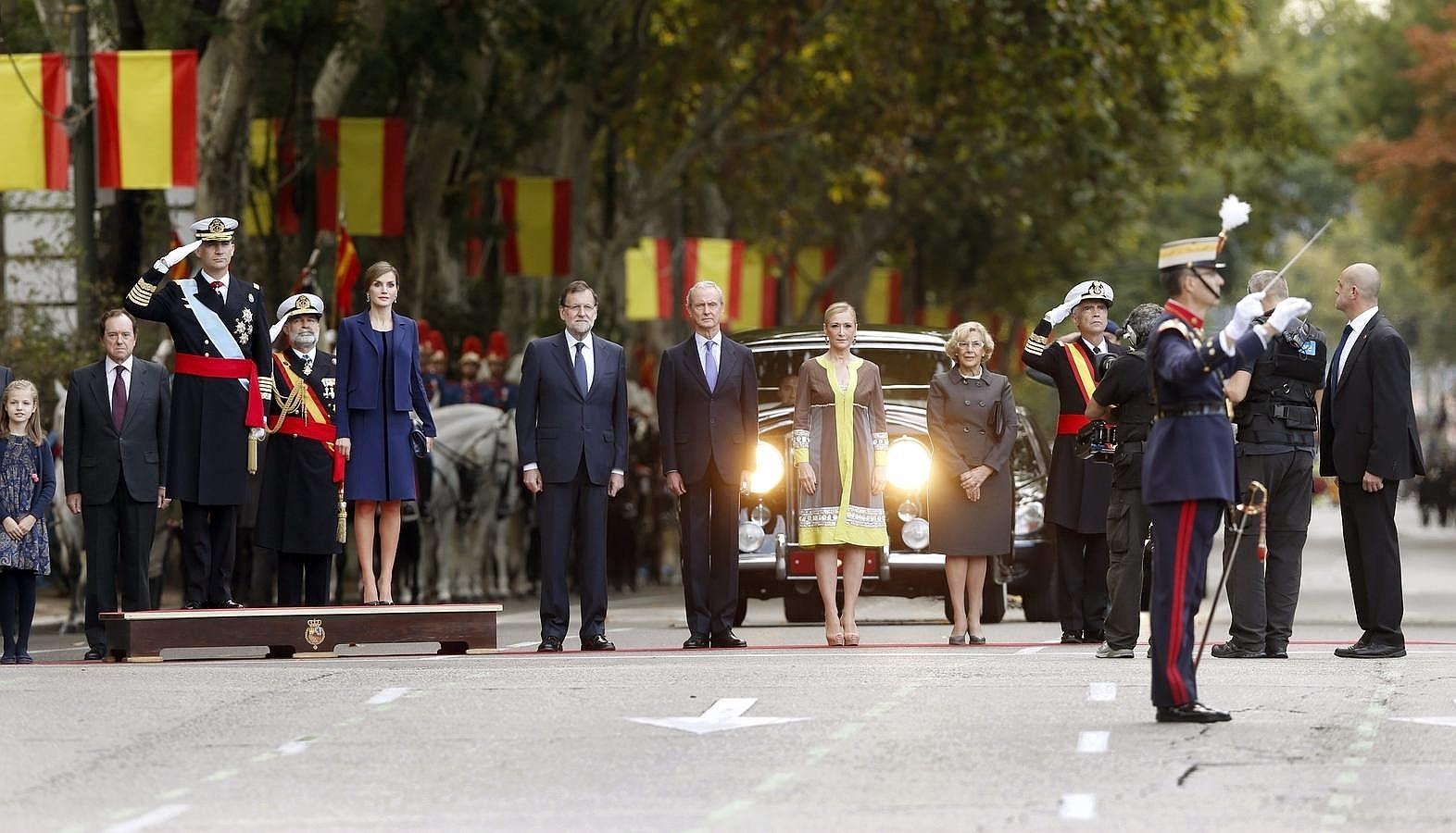 Los Reyes, acompañados por el ministro de Defensa, Pedro Morenés; la presidenta de la Comunidad de Madrid, Cristina Cifuentes, y la alcaldesa de la capital, Manuela Carmena, al inicio del desfile del Día de la Fiesta Nacional