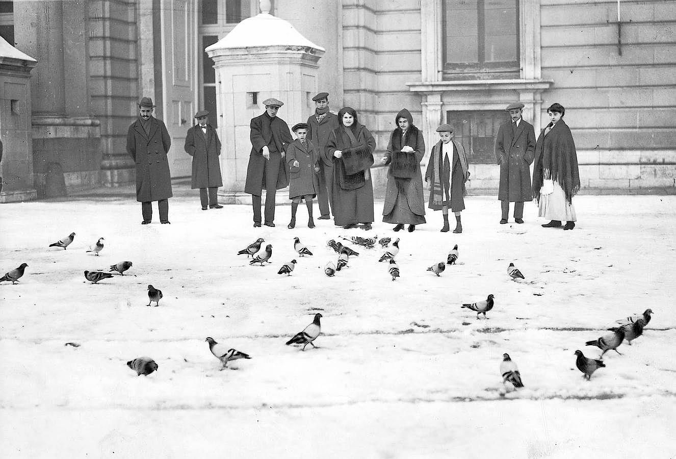 El público en la Plaza de la Armería dando de comer a las palomas de palacio, faltas de alimentación a consecuencia de la nevada de enero de 1914